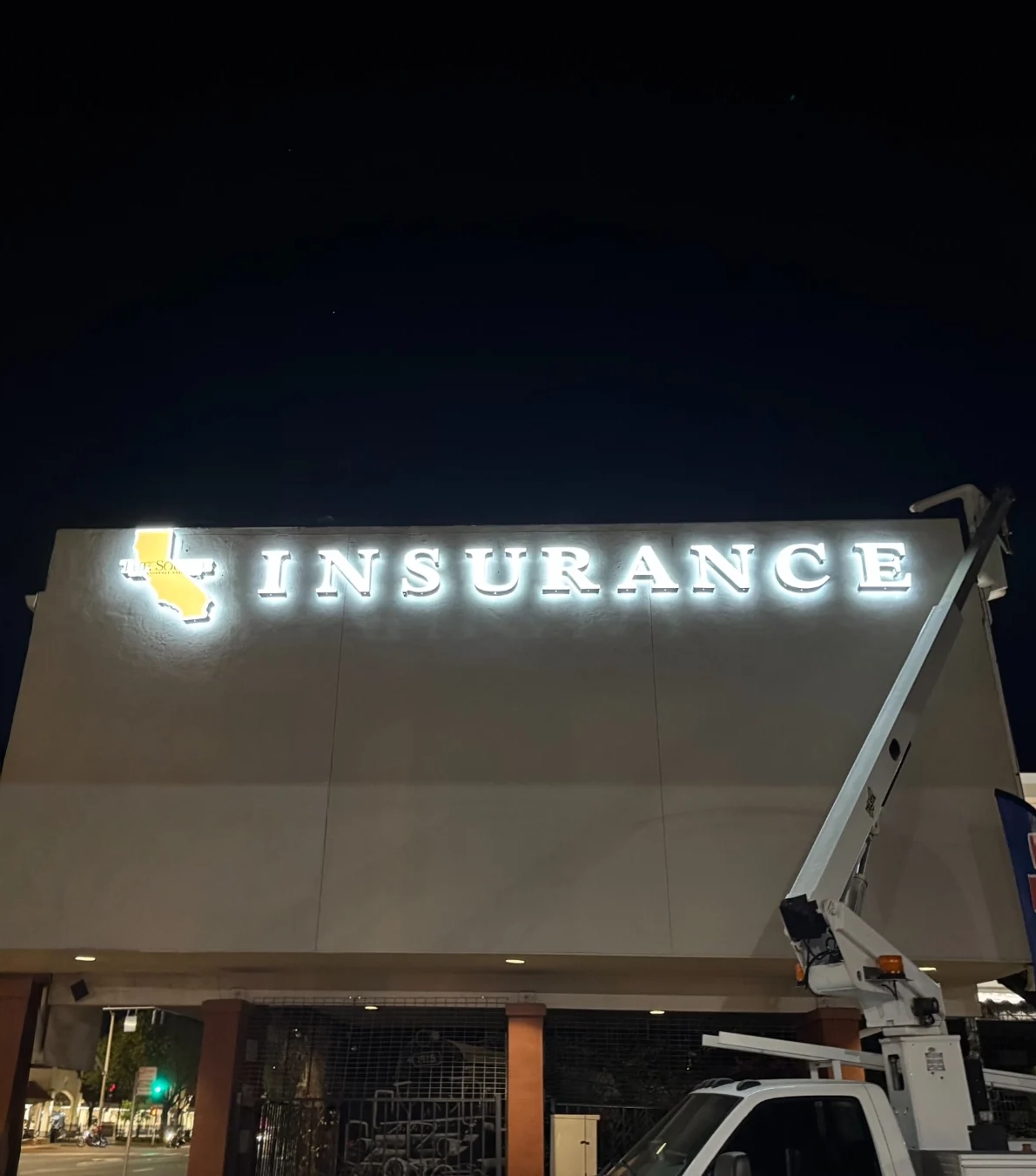 Large-format exterior illuminated business signage installed at night