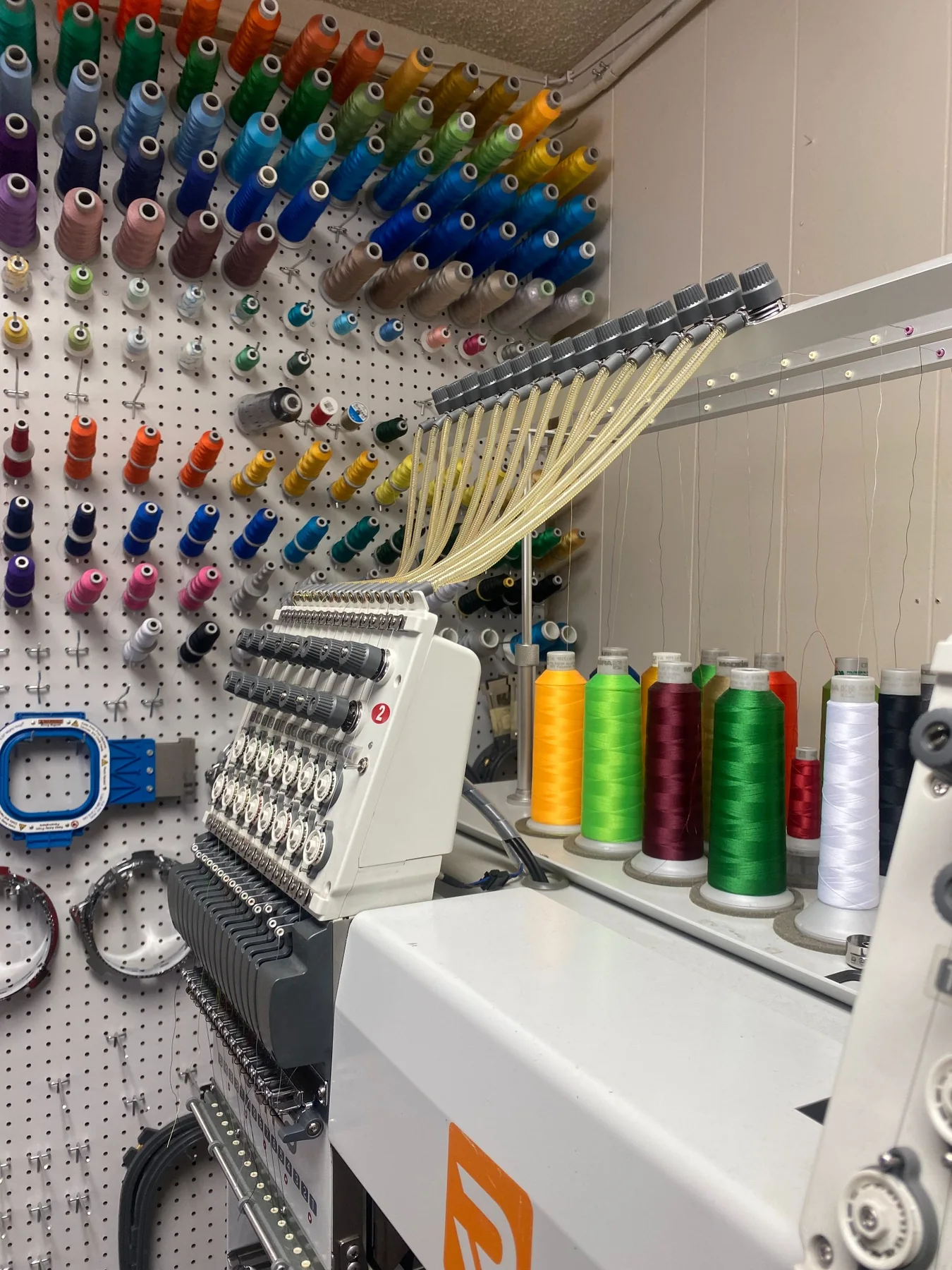 Embroidery machine and colorful thread in the PG Signs & Print shop