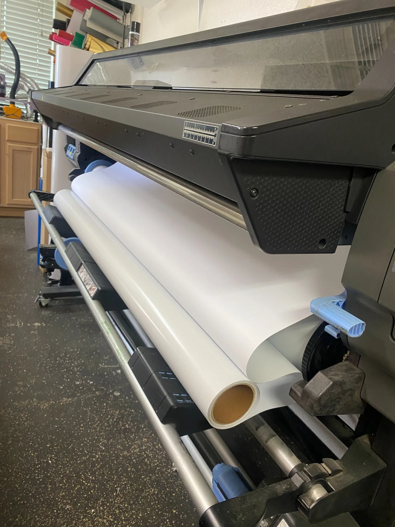 Wide-format printer producing custom signage material